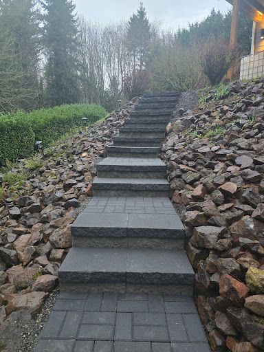 Stone paver stairway up a hillside with rock surrounds